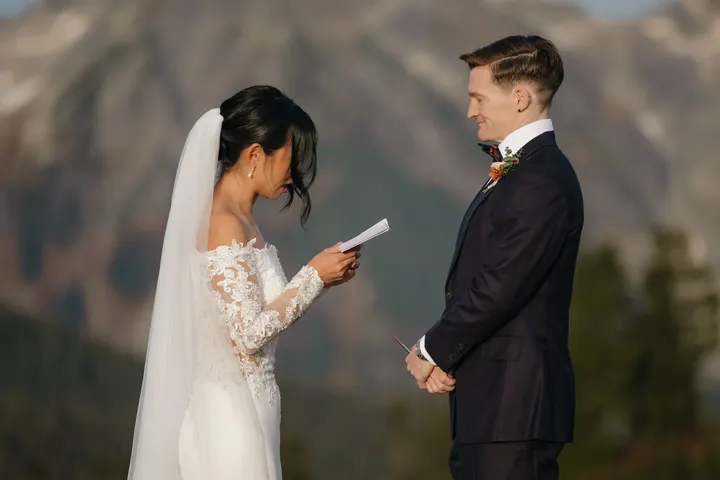Bride reading her vows to the groom in the mountains