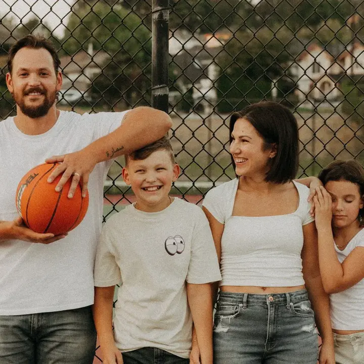 Family laughing on a basketball court