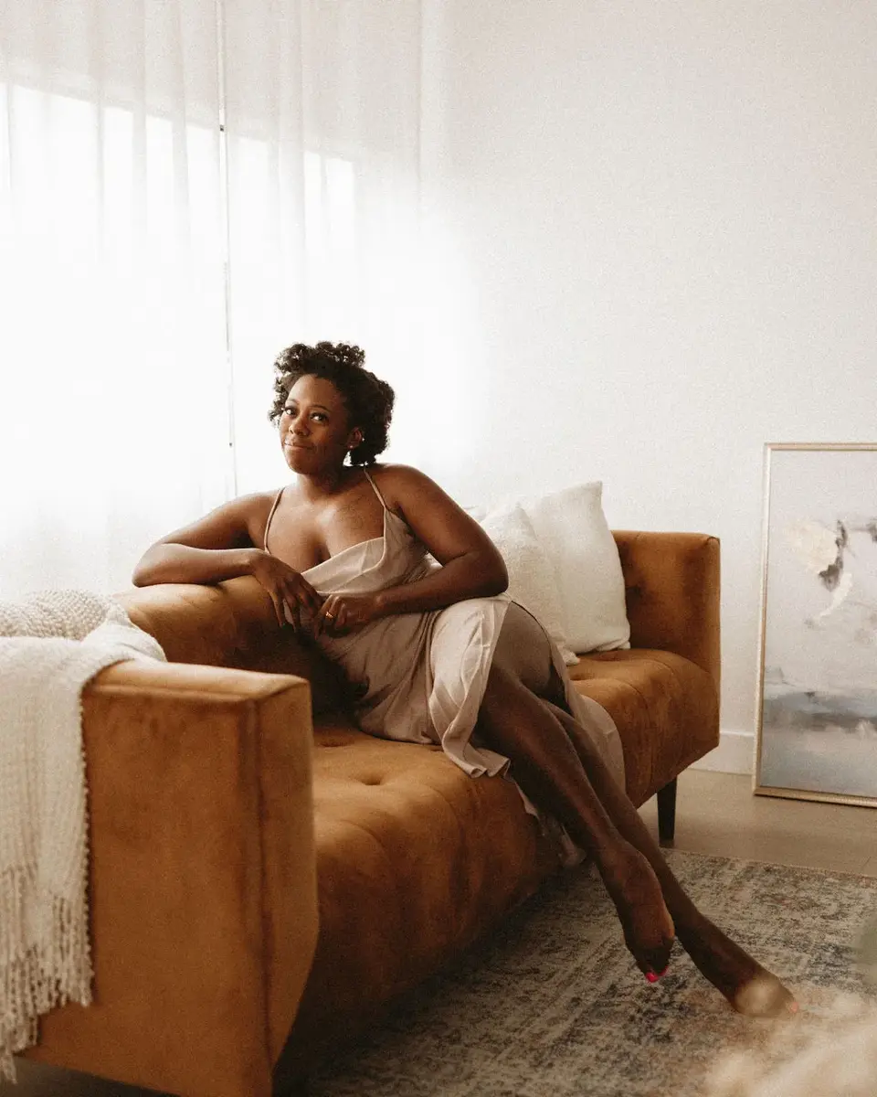 Boudoir portrait seated in warm studio light
