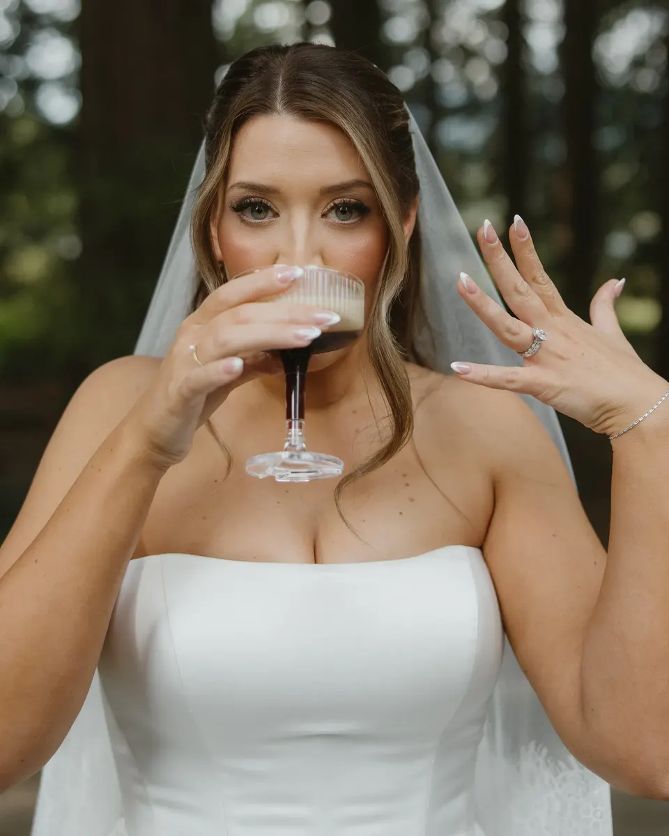 Bride sipping an espresso martini and showing off her ring