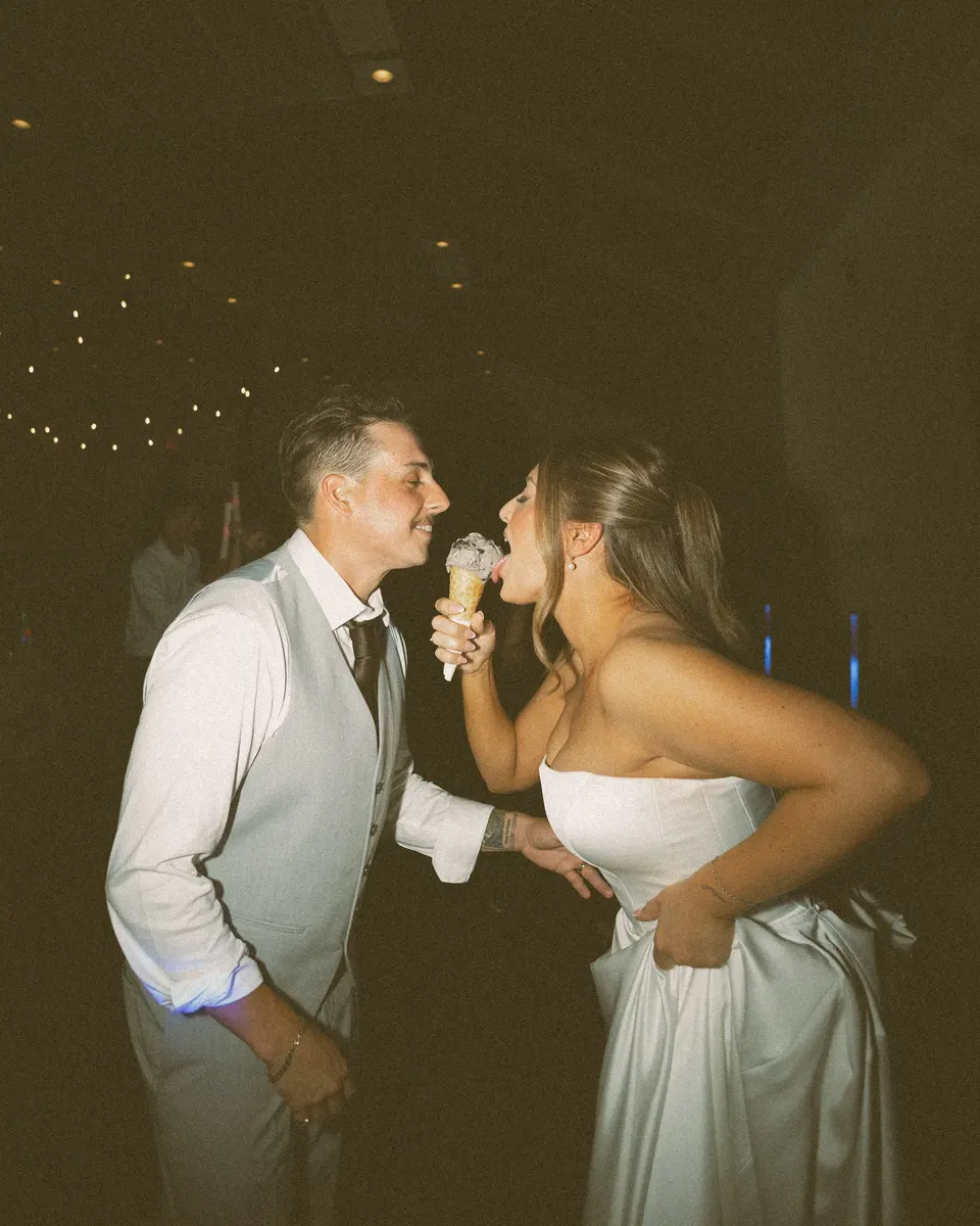 Bride and groom sharing ice cream on the dance floor