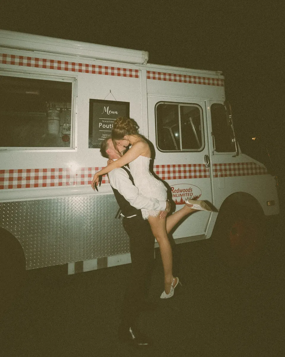 Couple kissing against a vintage ice cream truck